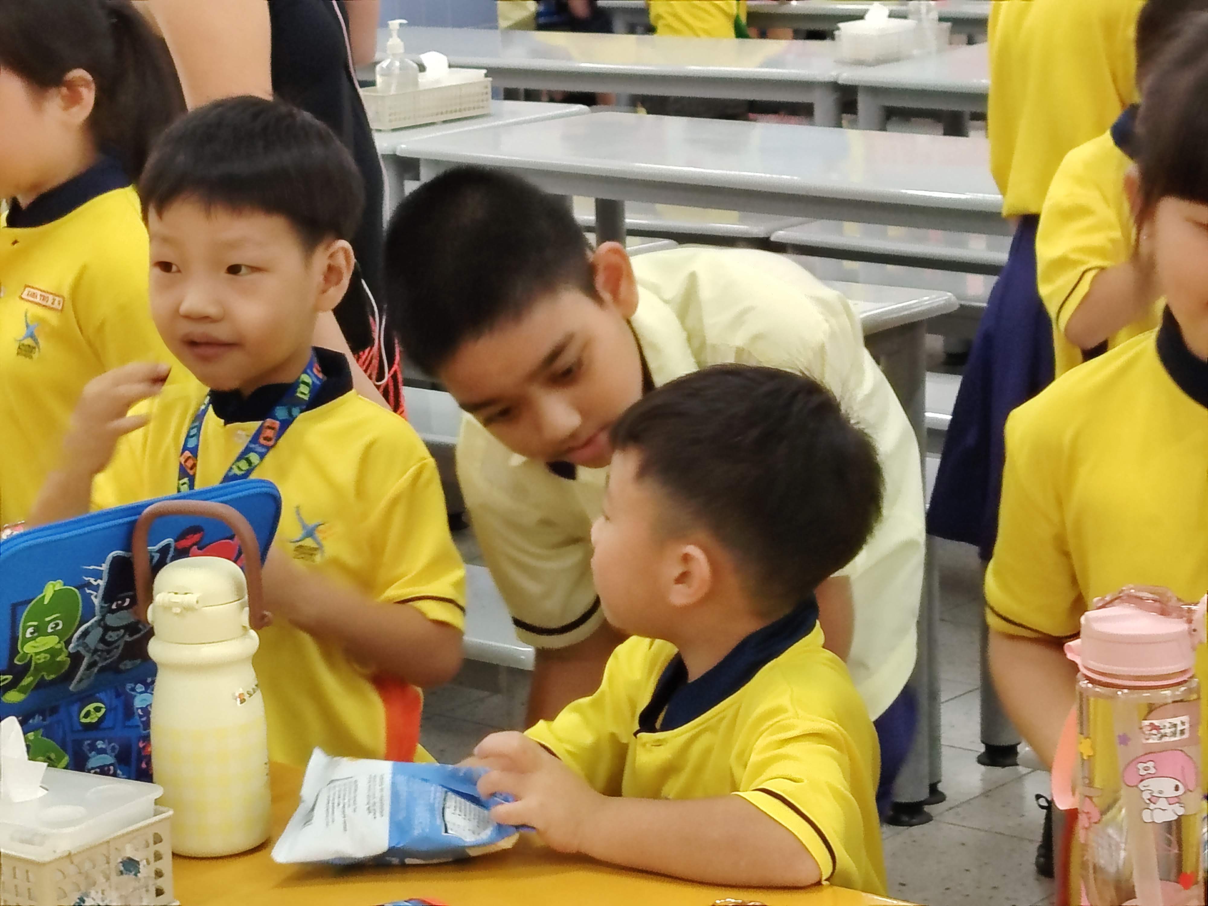 A P4 student looks after his P1 buddy during recess